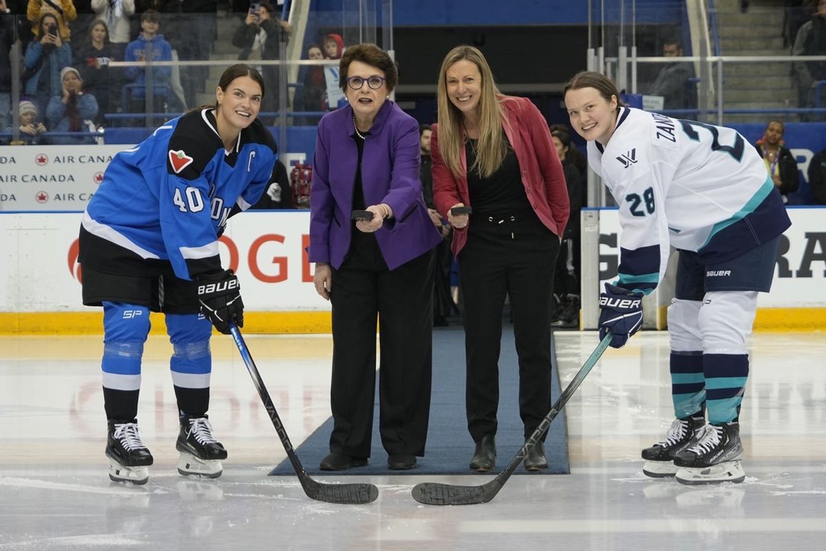 Jan 1, 2024; Toronto, Ontario, CANADA; Billie Jean King (purple blazer) and Jayna Hefford (red jacket)perform the ceremonial puck drop to Toronto forward Blayre Turnbull (40) and New York defender Micah Zandee-Hart (28) before the inaugural PWHL ice hockey game at Mattamy Athletic Centre. Mandatory Credit: John E. Sokolowski-Imagn Images