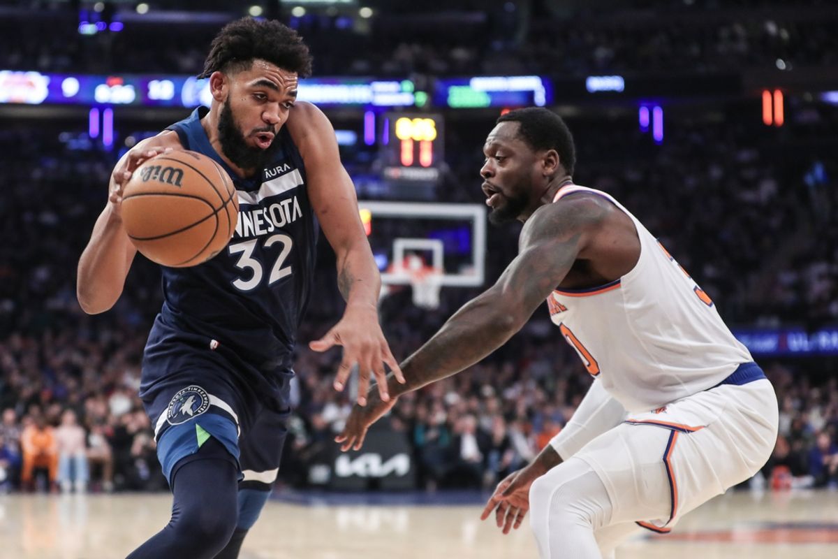 Jan 1, 2024; New York, New York, USA;  Minnesota Timberwolves center Karl-Anthony Towns (32) looks to drive past New York Knicks forward Julius Randle (30) in the first quarter at Madison Square Garden. Mandatory Credit: Wendell Cruz-Imagn Images