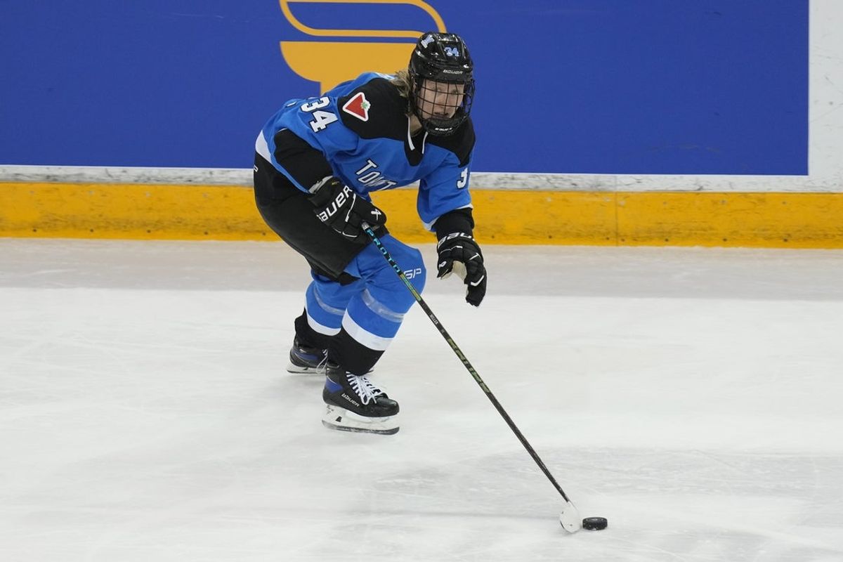 Jan 1, 2024; Toronto, Ontario, CANADA; Toronto forward Hannah Miller (34) carries the puck against New York during the second period of the inaugural PWHL ice hockey game at Mattamy Athletic Centre. Mandatory Credit: John E. Sokolowski-Imagn Images