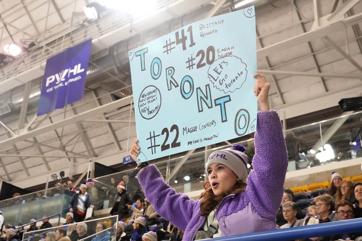Jan 1, 2024; Toronto, Ontario, CANADA; A Toronto fan holds up a sign during the inaugural PWHL ice hockey game against New York at Mattamy Athletic Centre. Mandatory Credit: John E. Sokolowski-Imagn Images