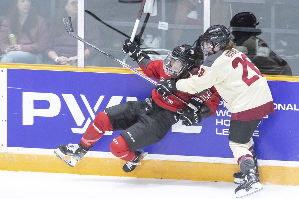 Jan 2, 2024; Ottawa, Ontario, CAN; Ottawa forward Katerina Mrazova (16) checks Montreal forward Sarah Bujold (26) into the boards in the first period in a PWHL hockey game at TD Place. Mandatory Credit: Marc DesRosiers-Imagn Images