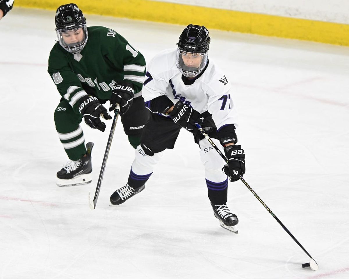 Jan 3, 2024; Lowell, MA, USA; Minnesota forward Susanna Tapani (77) skates against Boston defender Sophie Jaques (18) during the first period of a PWHL ice hockey game at Tsongas Center. Mandatory Credit: Brian Fluharty-USA TODAY Sports