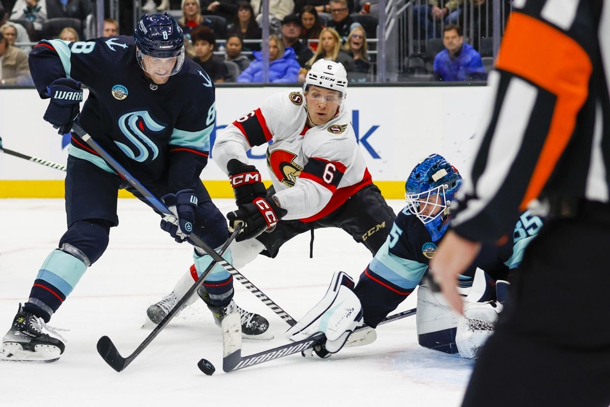 Jan 4, 2024; Seattle, Washington, USA; Seattle Kraken goaltender Joey Daccord (35) pokes the puck away from defenseman Brian Dumoulin (8) and Ottawa Senators defenseman Jakob Chychrun (6) during the third period at Climate Pledge Arena. Mandatory Credit: Joe Nicholson-Imagn Images