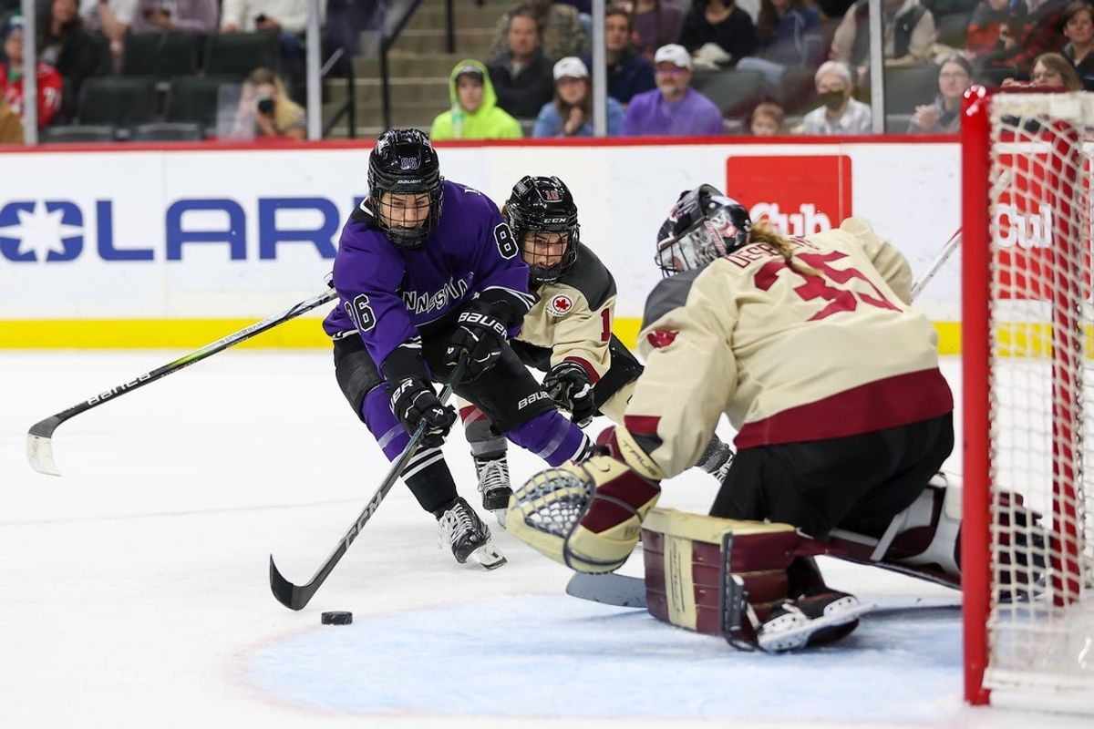 Jan 6, 2024; St. Paul, Minnesota, USA; Minnesota forward Michela Cava (86) shoots as Montreal defender Brigitte Lagani re (10) and goalie Ann-Ren e Desbiens (35) defend during the third period in a PWHL ice hockey game at XCel Energy Center. Mandatory Credit: Matt Krohn-Imagn Images