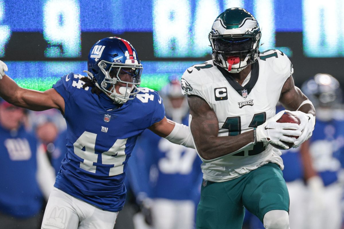 Jan 7, 2024; East Rutherford, New Jersey, USA; Philadelphia Eagles wide receiver A.J. Brown (11) catches the ball as New York Giants cornerback Nick McCloud (44) pursues during the first quarter at MetLife Stadium. Mandatory Credit: Vincent Carchietta-Imagn Images