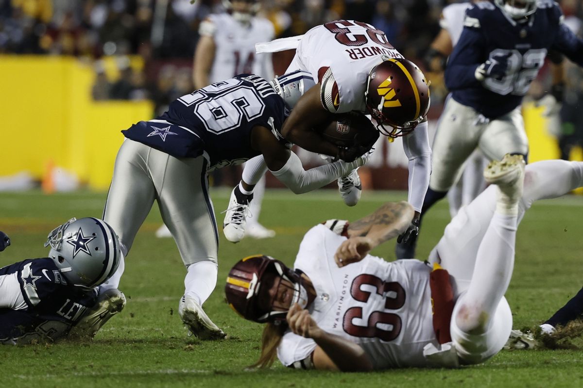 Jan 7, 2024; Landover, Maryland, USA; Washington Commanders wide receiver Jamison Crowder (83) is tackled by Dallas Cowboys cornerback DaRon Bland (26) during the second quarter at FedExField. Mandatory Credit: Geoff Burke-Imagn Images