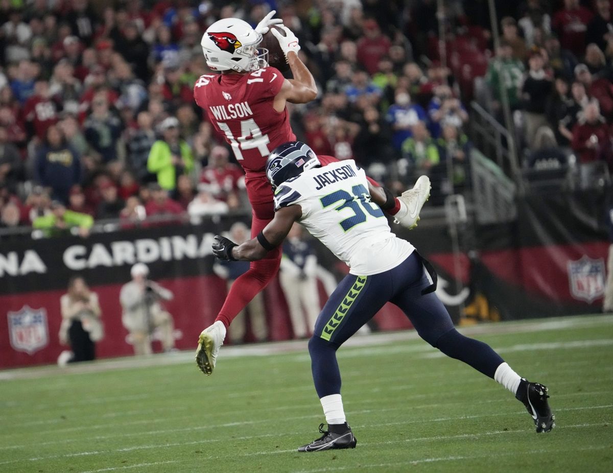 Arizona Cardinals wide receiver Michael Wilson (14) makes a catch against Seattle Seahawks cornerback Michael Jackson (30) during the fourth quarter at State Farm Stadium in Glendale on Jan. 7, 2024.