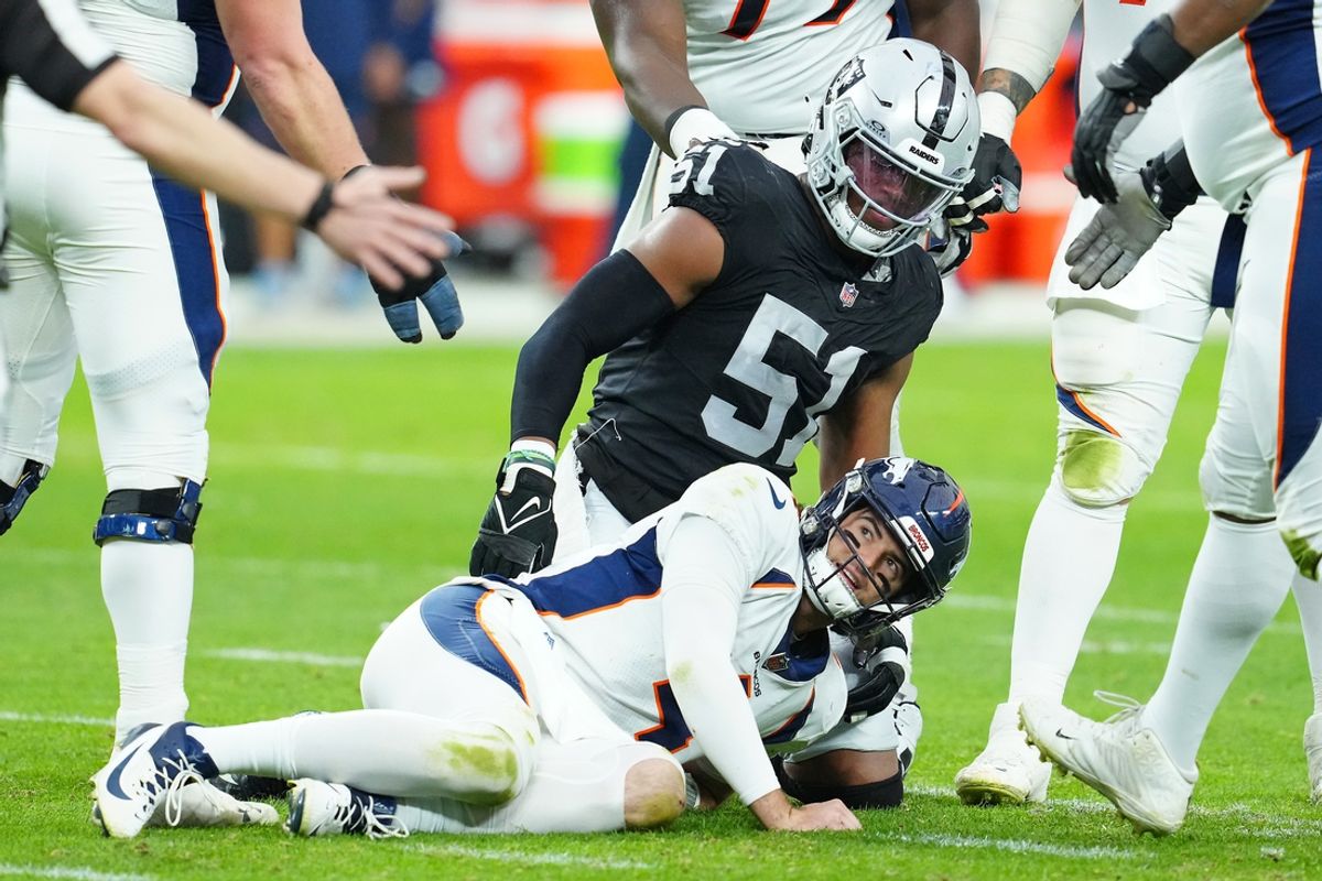 Jan 7, 2024; Paradise, Nevada, USA; Denver Broncos quarterback Jarrett Stidham (4) reacts after being knocked down by Las Vegas Raiders defensive end Malcolm Koonce (51) during the second quarter at Allegiant Stadium. Mandatory Credit: Stephen R. Sylvanie-Imagn Images