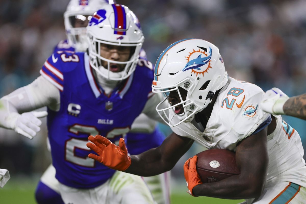 Jan 7, 2024; Miami Gardens, Florida, USA; Miami Dolphins running back De'Von Achane (28) runs with the football against the Buffalo Bills during the second quarter at Hard Rock Stadium. Mandatory Credit: Sam Navarro-Imagn Images