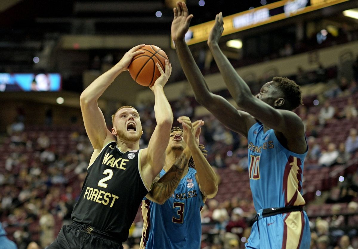 Jan 9, 2024; Tallahassee, Florida, USA; Wake Forest Demon Deacons guard Cameron Hildreth (2) shoots the ball over Florida State Seminoles guard Cam Corhen (3) and forward Bol Bowen (10) during the first half at Donald L. Tucker Center. Mandatory Credit: Melina Myers-Imagn Images