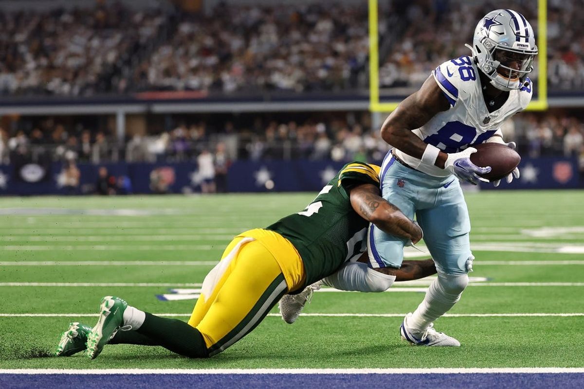 Jan 14, 2024; Arlington, Texas, USA; Dallas Cowboys wide receiver CeeDee Lamb (88) makes a catch against Green Bay Packers cornerback Corey Ballentine (35) in the first half of the 2024 NFC wild card game at AT&T Stadium. Mandatory Credit: Kevin Jairaj-USA TODAY Sports