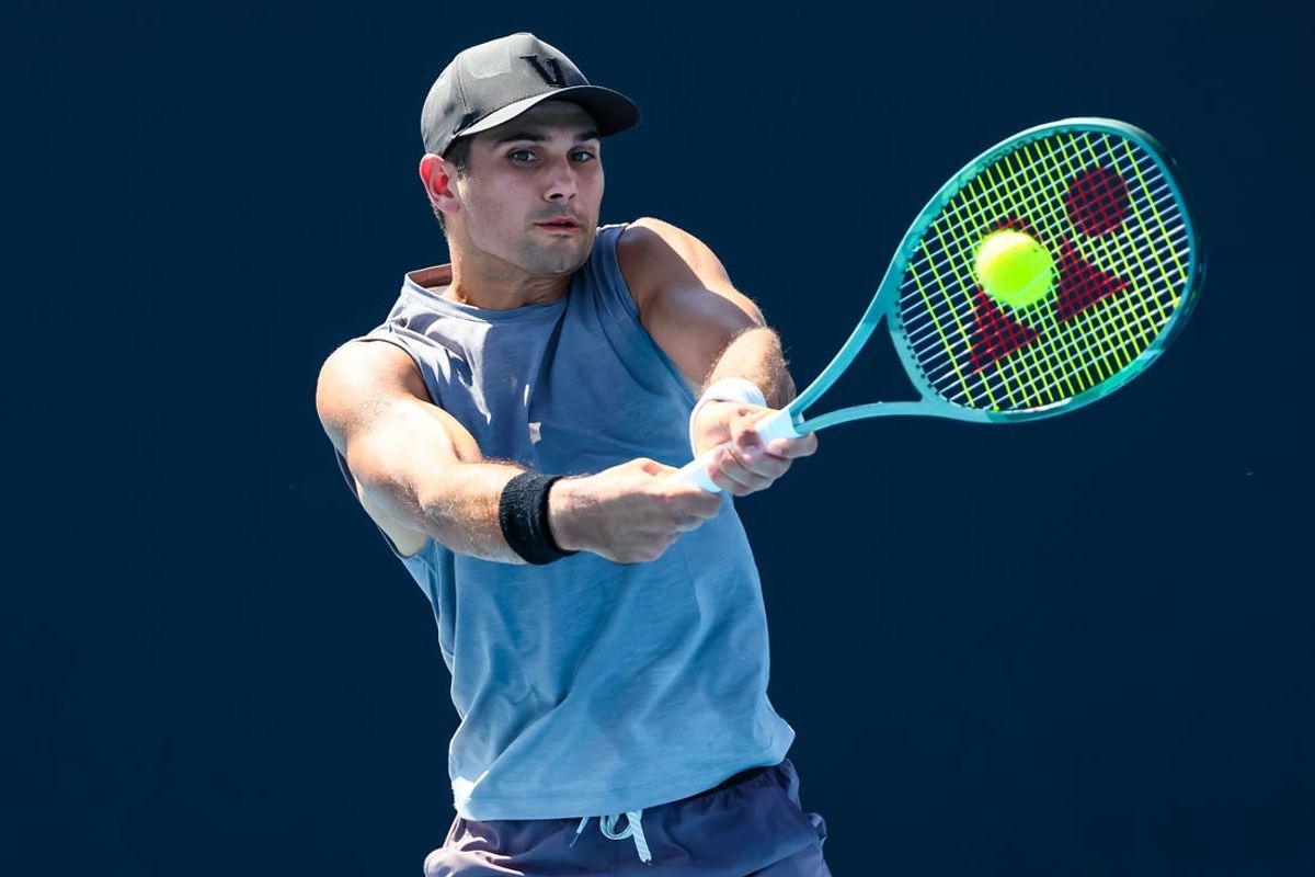 Jan 16, 2024; Melbourne, Victoria, Australia; Marcos Giron of the United States plays a shot against Jack Draper (not pictured) of Great Britain in Round 1 of the Men's Singles on Day 3 of the Australian Open tennis at Rod Laver Arena. Mandatory Credit: Mike Frey-USA TODAY Sports