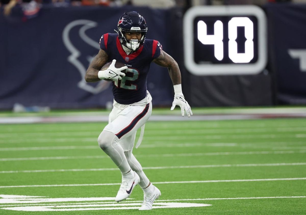 Jan 13, 2024; Houston, Texas, USA; Houston Texans wide receiver Nico Collins (12) runs after his reception against the Cleveland Browns in a 2024 AFC wild card game at NRG Stadium. Mandatory Credit: Thomas Shea-USA TODAY Sports