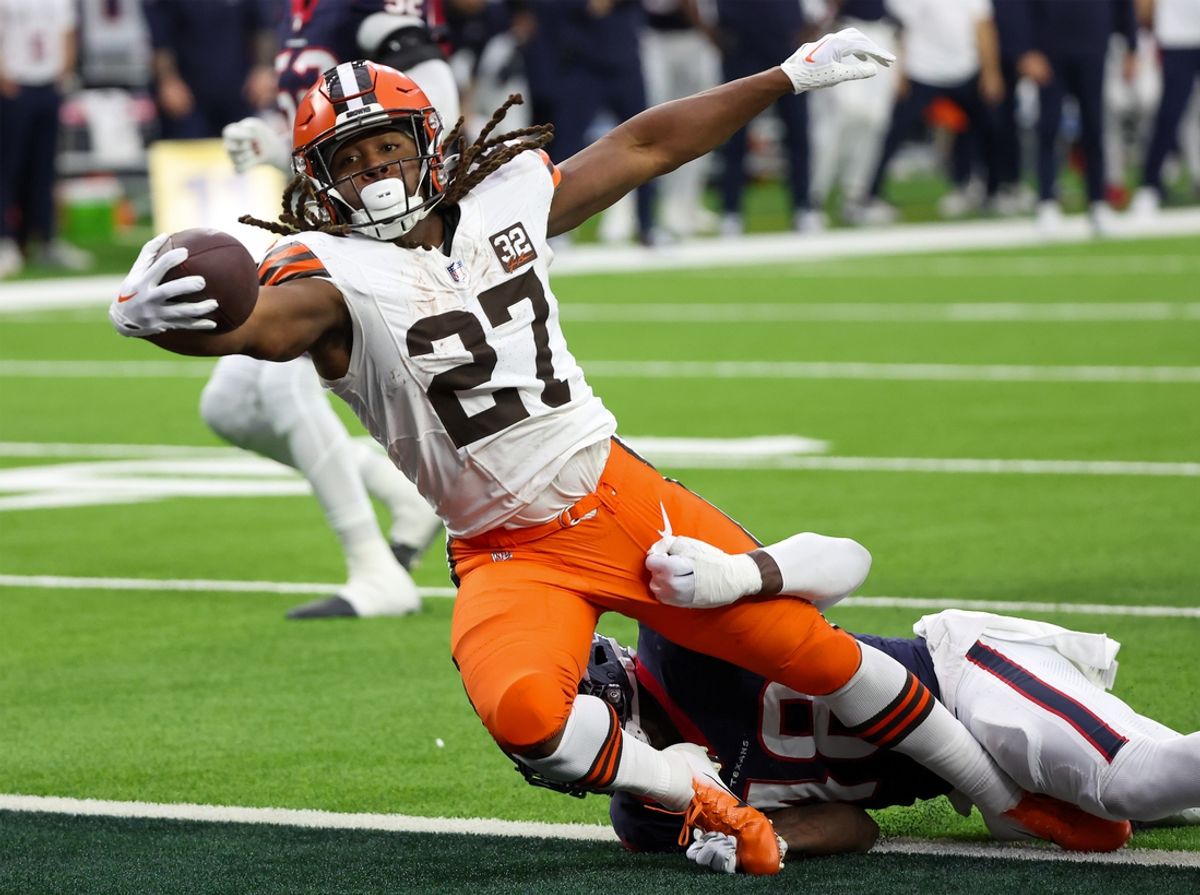 Jan 13, 2024; Houston, Texas, USA; Cleveland Browns running back Kareem Hunt (27) breaks the tackle of Houston Texans linebacker Christian Harris (48) as he scores a touchdown in a 2024 AFC wild card game at NRG Stadium. Mandatory Credit: Thomas Shea-Imagn Images