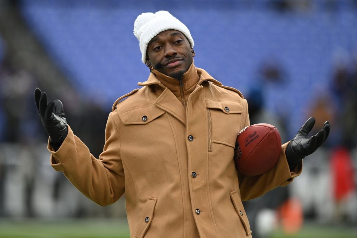 Jan 20, 2024; Baltimore, MD, USA; ESPN college football and NFL analyst Robert Griffin III reacts on the sidelines before a 2024 AFC divisional round game between the Houston Texans and the Baltimore Ravens at M&T Bank Stadium. Mandatory Credit: Tommy Gilligan-Imagn Images
