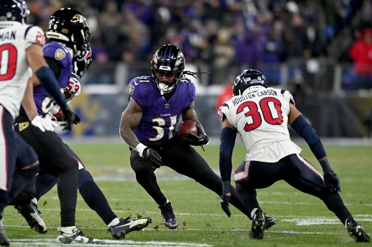 Jan 20, 2024; Baltimore, MD, USA; Baltimore Ravens running back Dalvin Cook (31) runs the ball against Houston Texans linebacker Blake Cashman (53) and safety DeAndre Houston-Carson (30) during the fourth quarter of a 2024 AFC divisional round game at M&T Bank Stadium. Mandatory Credit: Tommy Gilligan-Imagn Images