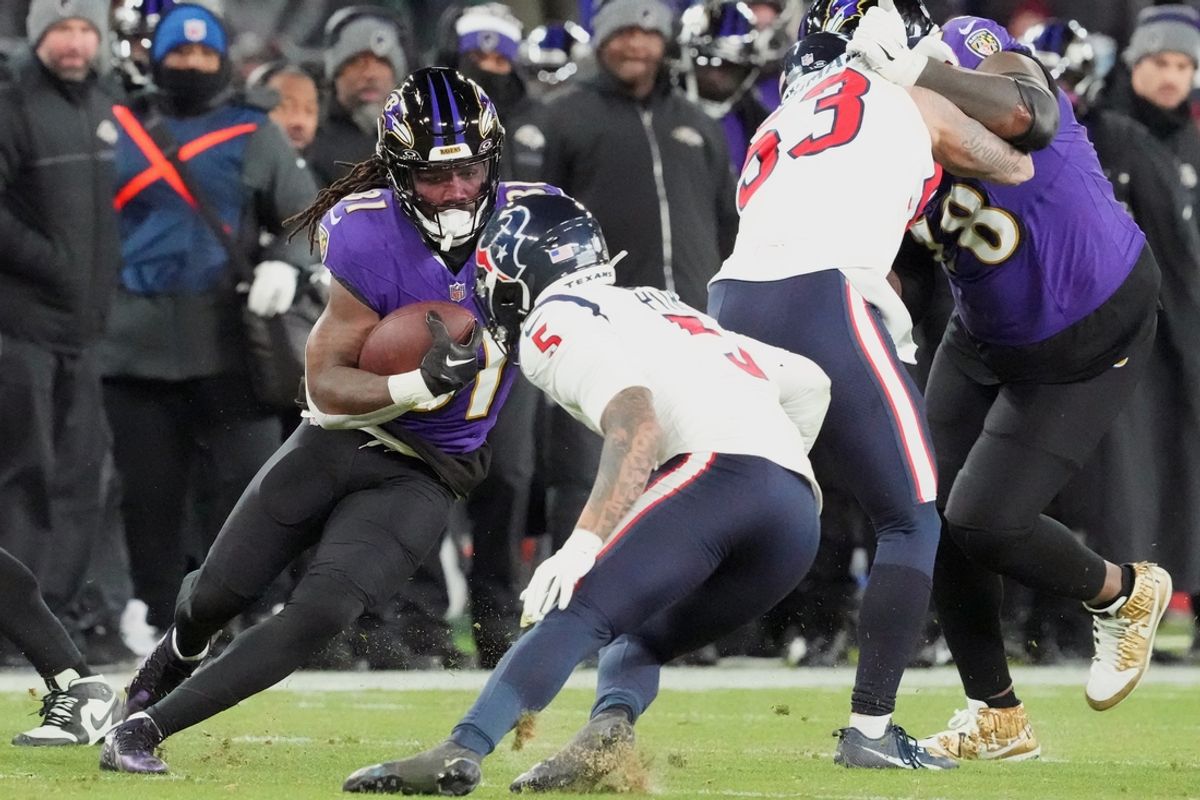 Jan 20, 2024; Baltimore, MD, USA; Baltimore Ravens running back Dalvin Cook (31) runs the ball against Houston Texans safety Jalen Pitre (5) during the fourth quarter of a 2024 AFC divisional round game at M&T Bank Stadium. Mandatory Credit: Mitch Stringer-USA TODAY Sports