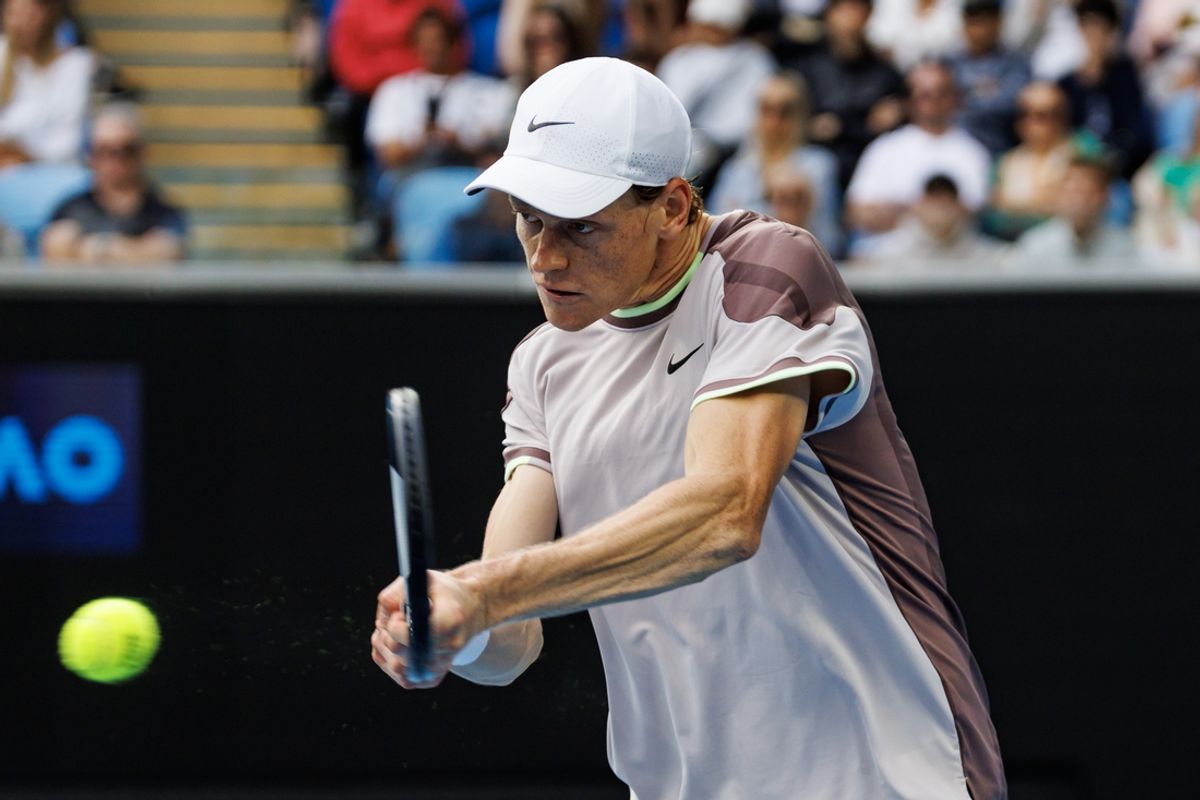 Jan 21, 2024; Melbourne, Victoria, Australia;  Janik Sinner of Italy hits a shot against Karen Kachanov of Russia in the forth round of the men s singles at the Australian Open 2024. Mandatory Credit: Mike Frey-Imagn Images