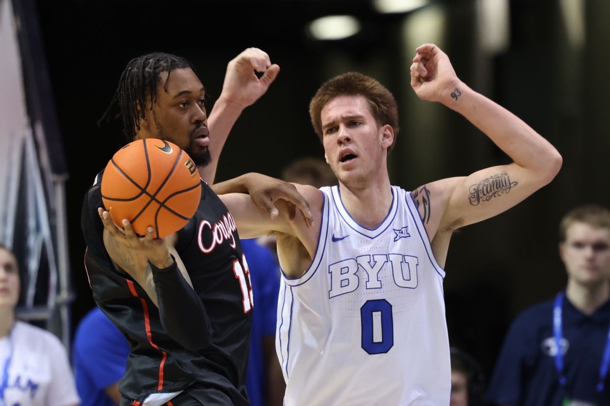 Jan 23, 2024; Provo, Utah, USA; Houston Cougars forward J'Wan Roberts (13) holds the ball away from Brigham Young Cougars forward Noah Waterman (0) during the second half at Marriott Center. Mandatory Credit: Rob Gray-Imagn Images