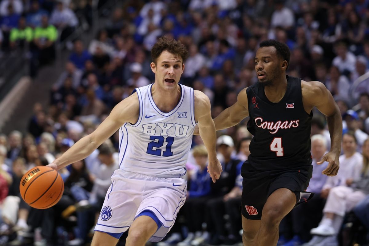 Jan 23, 2024; Provo, Utah, USA; Brigham Young Cougars guard Trevin Knell (21) dribbles the basketball while defended by Houston Cougars guard L.J. Cryer (4) during the second half at Marriott Center. Mandatory Credit: Rob Gray-Imagn Images