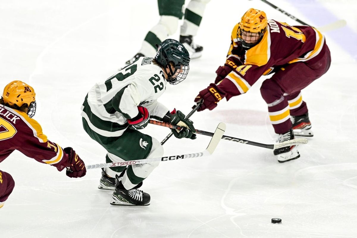 Michigan State's Isaac Howard, left, moves the puck as Minnesota's Oliver Moore, right, defends during the first period on Friday, Jan. 26, 2024, at Munn Arena in East Lansing.