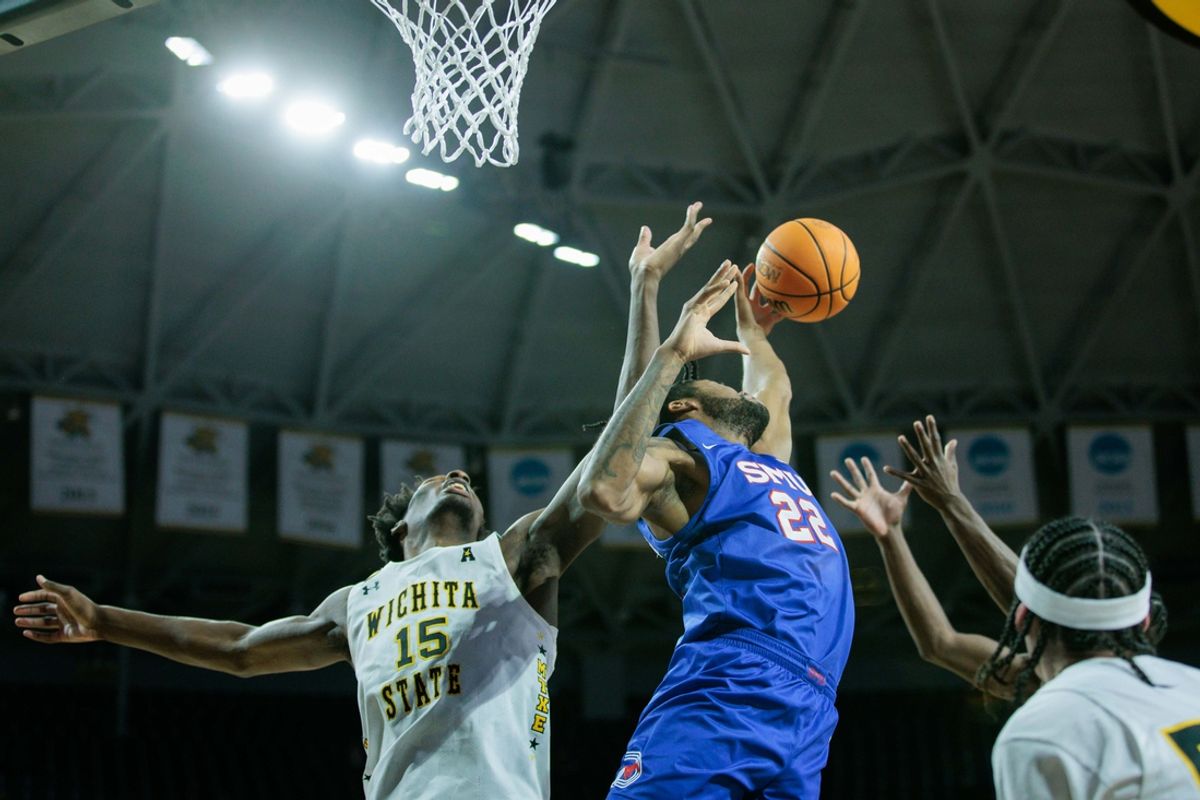 Jan 28, 2024; Wichita, Kansas, USA; Southern Methodist Mustangs forward Keon Ambrose-Hylton (22) and Wichita State Shockers center Quincy Ballard (15) go after a rebound during the second half at Charles Koch Arena. Mandatory Credit: William Purnell-Imagn Images