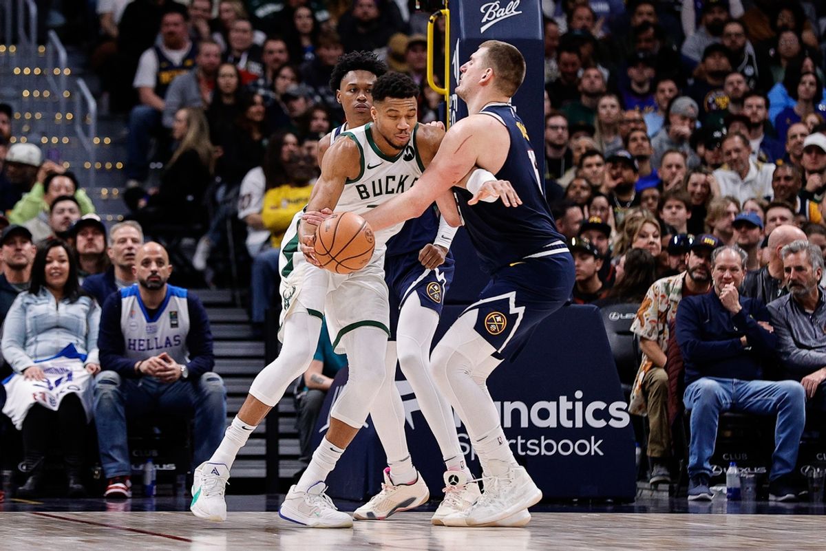 Jan 29, 2024; Denver, Colorado, USA; Milwaukee Bucks forward Giannis Antetokounmpo (34) controls the ball under pressure from Denver Nuggets center Nikola Jokic (15) and forward Peyton Watson (8) in the fourth quarter at Ball Arena. Mandatory Credit: Isaiah J. Downing-Imagn Images