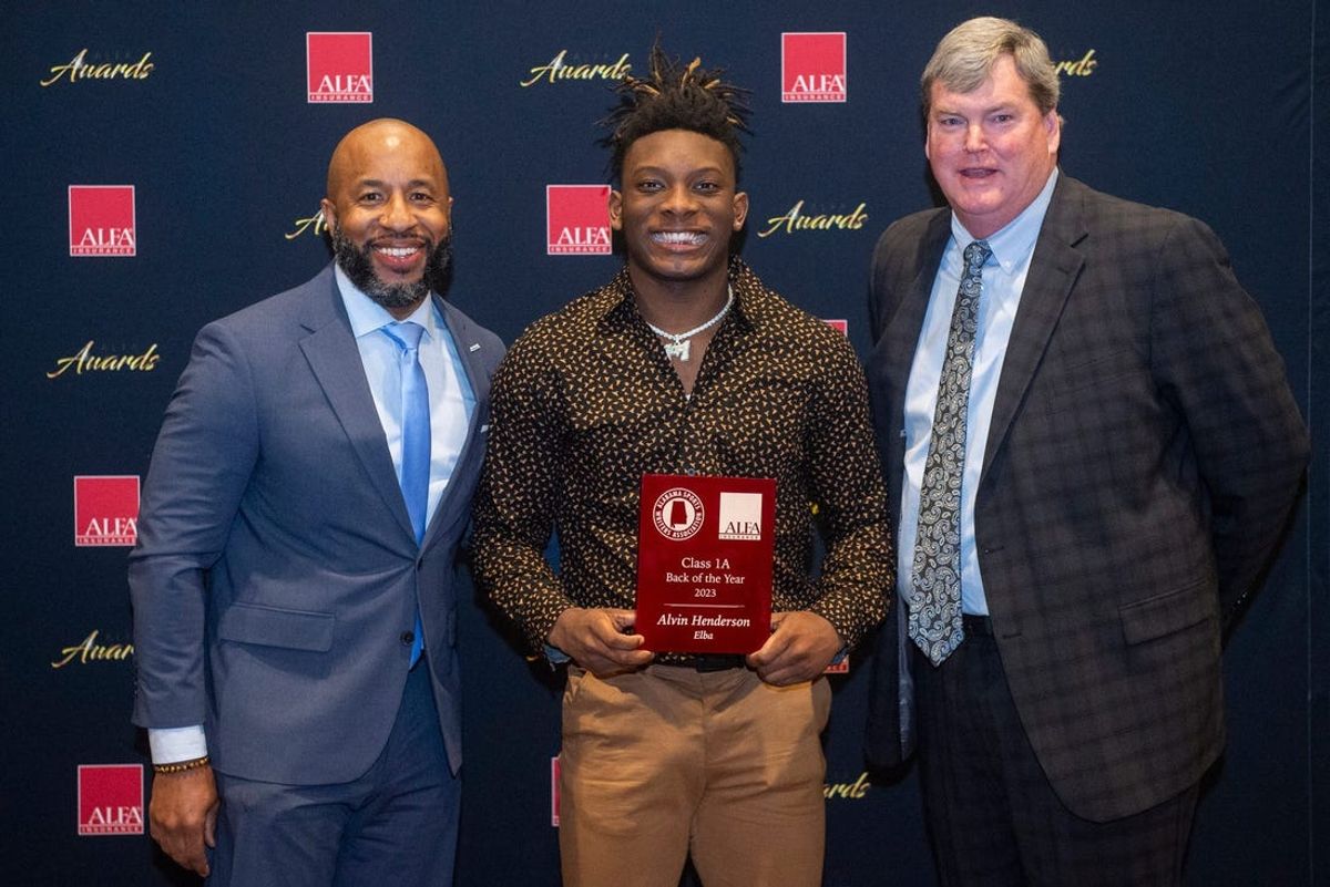 Class 1A back of the year Elba's Alvin Henderson poses with Brandon Dean, director of Alabama High School Athletic Directors and Coaches Association, left, and Alfa Insurance   s Scott Stricklin, right, during the Alabama Sports Writers Association   s players of the year banquet at Renaissance Hotel in Montgomery, Ala., on Tuesday, Jan. 30, 2024.