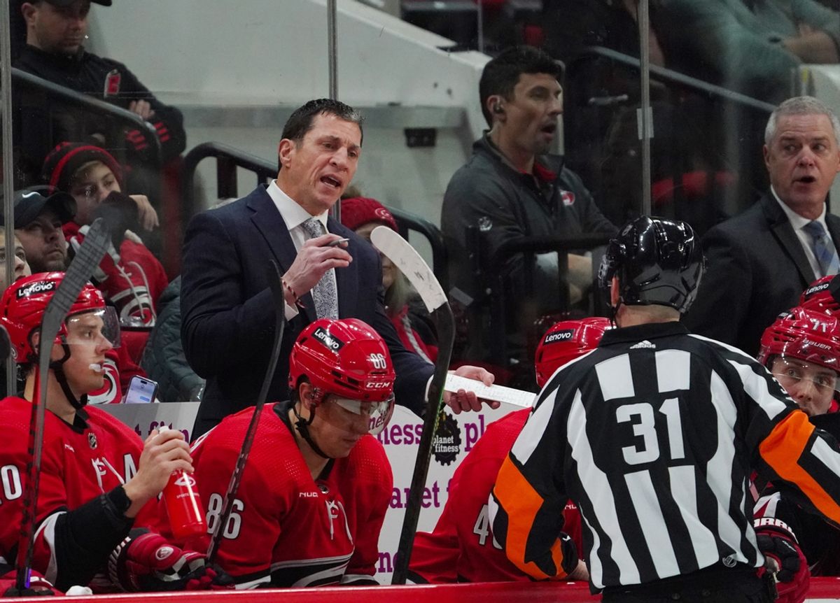 Feb 6, 2024; Raleigh, North Carolina, USA; Carolina Hurricanes head coach Rod Brind   Amour talks to referee Michael Markovic (31) against the Vancouver Canucks during the second period at PNC Arena. Mandatory Credit: James Guillory-Imagn Images