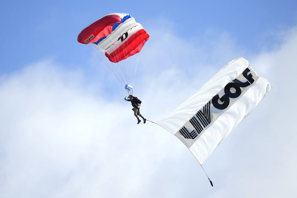Feb 8, 2024; Las Vegas, Nevada, USA; The Extreme Aerial Parachute Team fly overhead with a LIV flag prior to the first round of the LIV Golf Las Vegas tournament at Las Vegas Country Club. Mandatory Credit: Lucas Peltier-Imagn Images