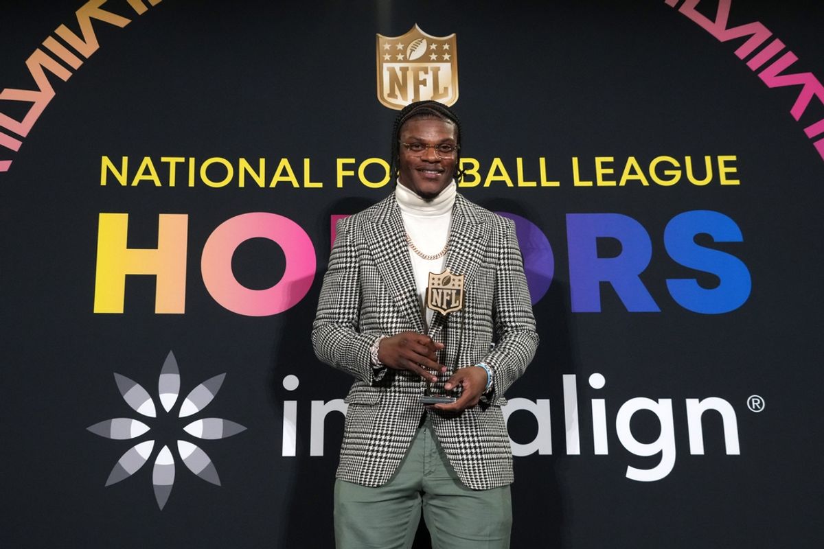 Baltimore Ravens quarterback Lamar Jackson poses with the most valuable player trophy during the Pro Football Hall of Fame Class of 2024 press conference at the Resorts World Theatre. Mandatory Credit: Kirby Lee-Imagn Images