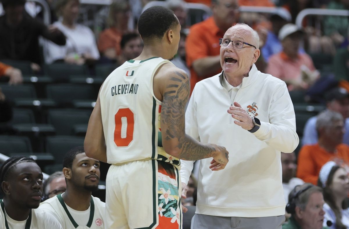 Feb 10, 2024; Coral Gables, Florida, USA; Miami Hurricanes head coach Jim Larranaga talks to guard Matthew Cleveland (0) against the North Carolina Tar Heels during the first half at Watsco Center. Mandatory Credit: Sam Navarro-Imagn Images