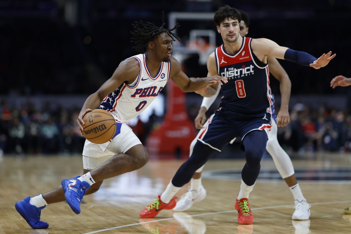 Feb 10, 2024; Washington, District of Columbia, USA; Philadelphia 76ers guard Tyrese Maxey (0) drives to the basket as Washington Wizards forward Deni Avdija (8) defends in the first half at Capital One Arena. Mandatory Credit: Geoff Burke-Imagn Images