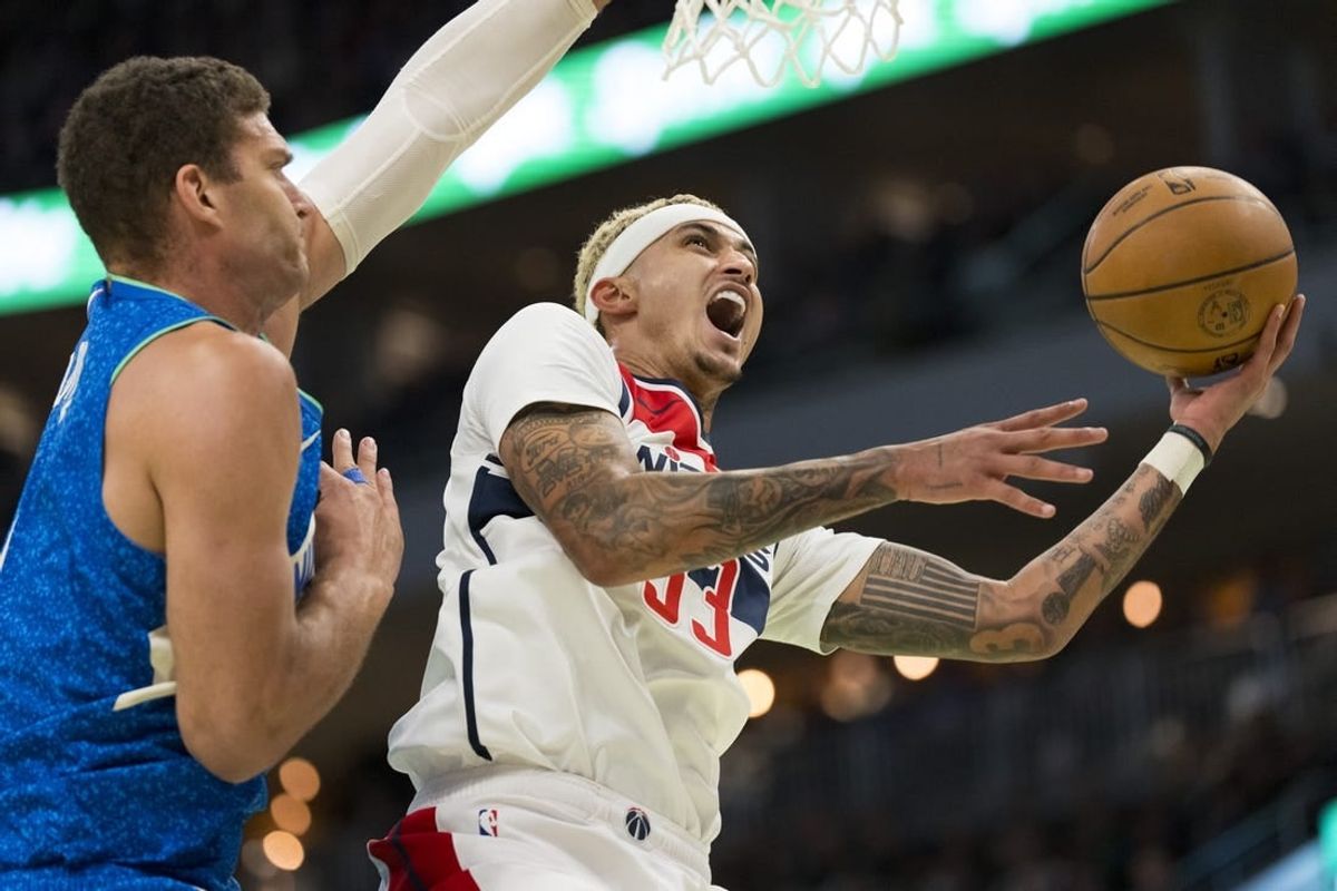 Nov 24, 2023; Milwaukee, Wisconsin, USA;  Washington Wizards forward Kyle Kuzma (33) shoots against Milwaukee Bucks center Brook Lopez (11) during the second quarter at Fiserv Forum.
