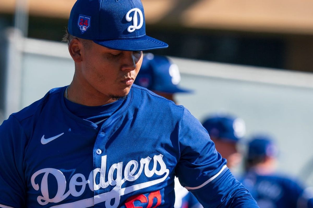 Feb 11, 2024; Glendale, AZ, USA; Los Angeles Dodgers pitcher Eduardo Salazar (60) works alongside members of his team on the practice mound at Camelback Ranch during Spring Training Workouts. Mandatory Credit: Allan Henry-USA TODAY Sports