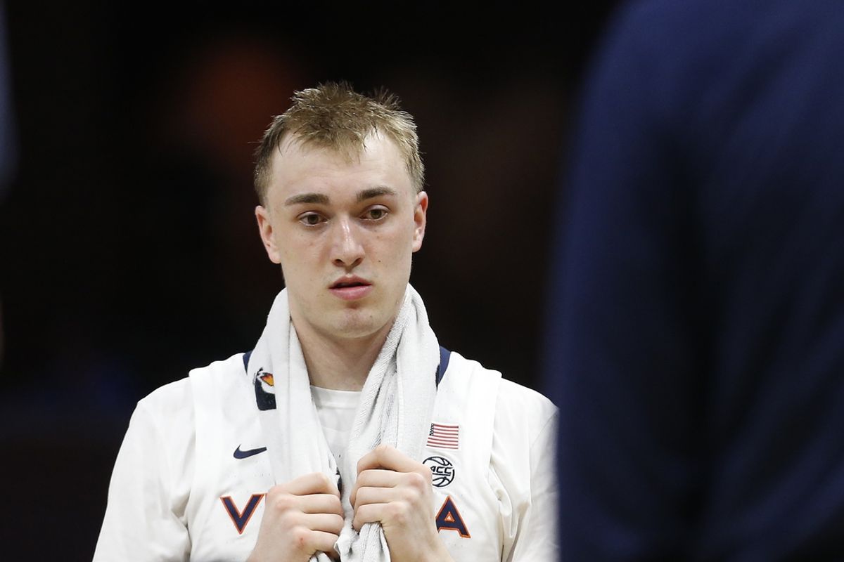 Feb 13, 2024; Charlottesville, Virginia, USA; Virginia Cavaliers guard Andrew Rohde (4) huddles with teammates during a stoppage in play in the second half against the Pittsburgh Panthers at John Paul Jones Arena. Mandatory Credit: Amber Searls-Imagn Images