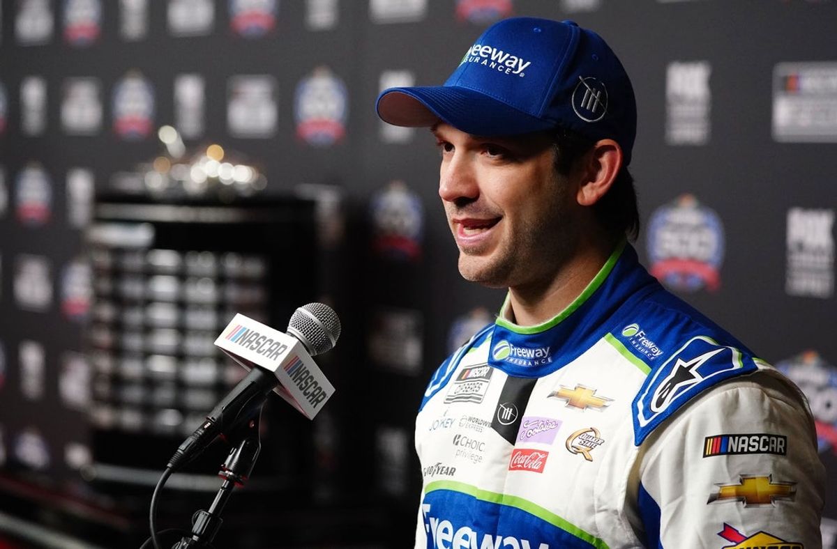 Feb 14, 2024; Daytona Beach, Florida, USA; NASCAR Cup Series driver Daniel Suarez (99) speaks with reporters during media day at Daytona International Speedway. Mandatory Credit: John David Mercer-Imagn Images