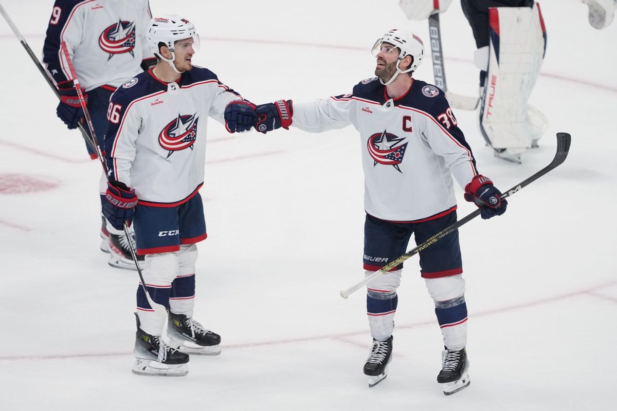 Feb 17, 2024; San Jose, California, USA; Columbus Blue Jackets center Boone Jenner (38) celebrates with right wing Kirill Marchenko (86) after scoring a goal against the San Jose Sharks during the third period at SAP Center at San Jose. Mandatory Credit: Darren Yamashita-Imagn Images