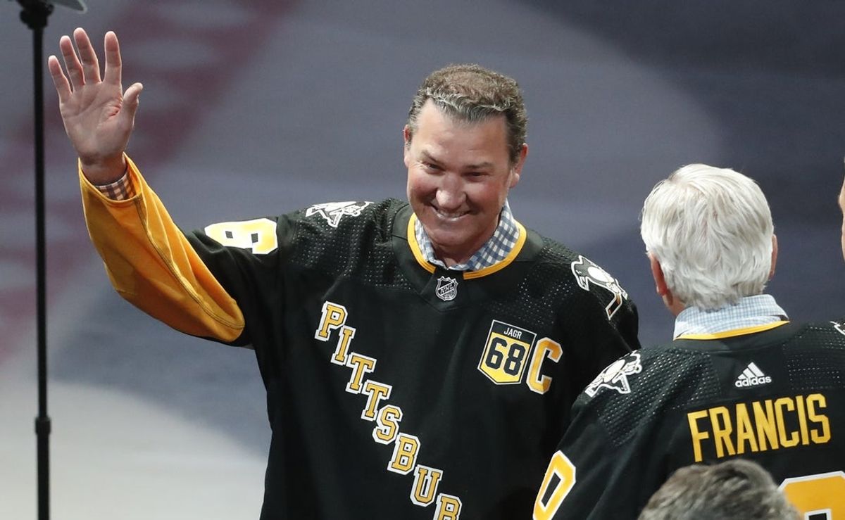 Feb 18, 2024; Pittsburgh, Pennsylvania, USA;  Pittsburgh Penguins former center Mario Lemieux gestures to the crowd during a ceremony to retire the jersey number of Penguins former right wing Jaromir Jagr (not pictured) at PPG Paints Arena. The Penguins host the Los Angeles Kings after the ceremony. Mandatory Credit: Charles LeClaire-Imagn Images