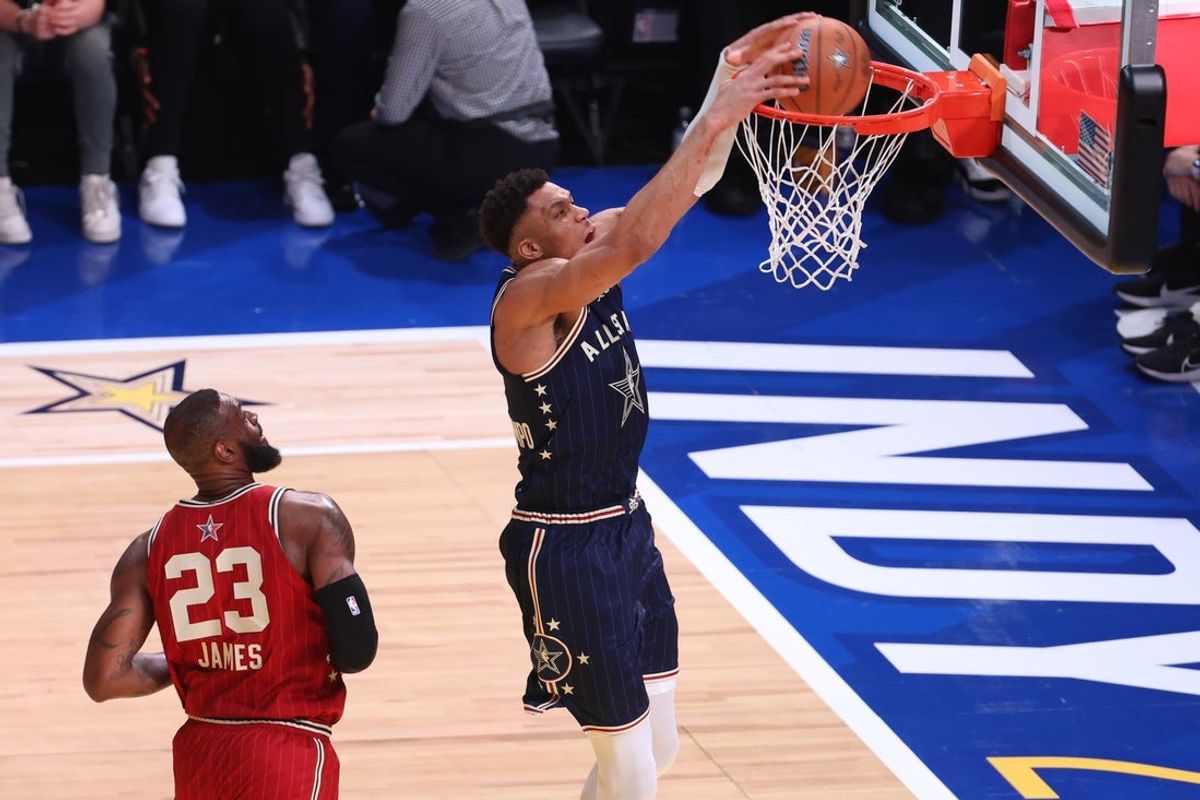 Feb 18, 2024; Indianapolis, Indiana, USA; Eastern Conference forward Giannis Antetokounmpo (34) of the Milwaukee Bucks dunks the ball past Western Conference forward LeBron James (23) of the Los Angeles Lakers during the first quarter in the 73rd NBA All Star game at Gainbridge Fieldhouse. Mandatory Credit: Trevor Ruszkowski-Imagn Images