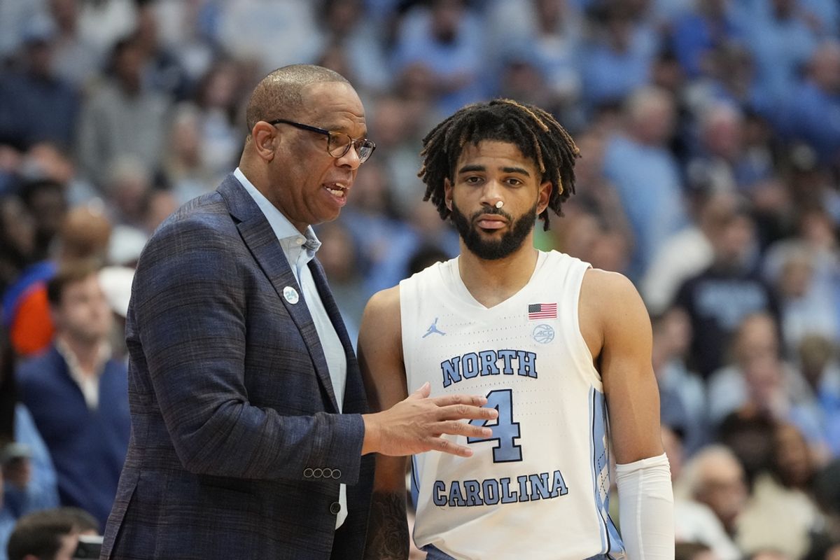 Feb 26, 2024; Chapel Hill, North Carolina, USA; North Carolina Tar Heels head coach Hubert Davis with guard RJ Davis (4) in the second half at Dean E. Smith Center. Mandatory Credit: Bob Donnan-Imagn Images