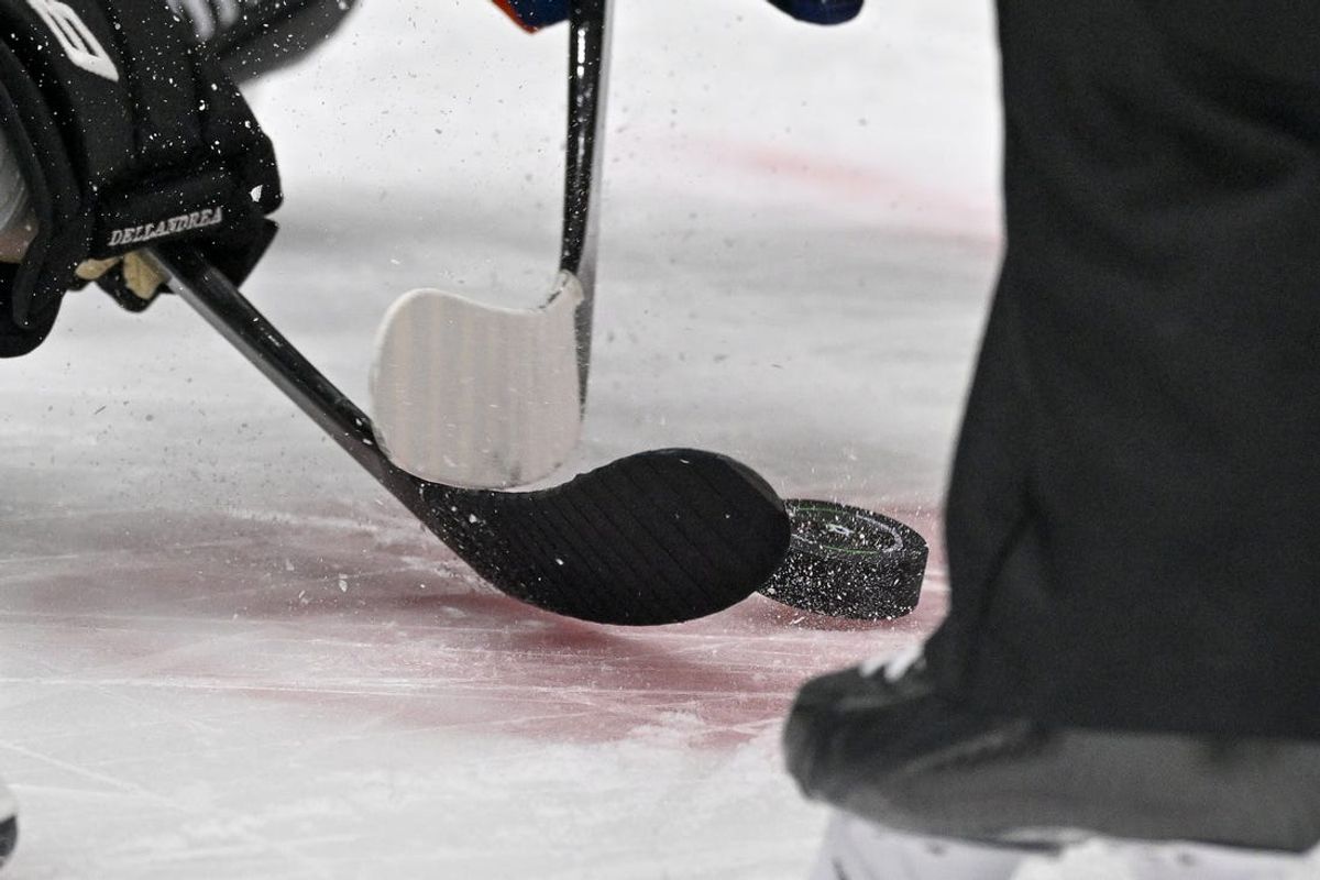 Feb 26, 2024; Dallas, Texas, USA; A view of the face-off circle and an NHL puck and the Dallas Stars logo and hockey sticks during a face-off in the third period of the game between the Dallas Stars and the New York Islanders at the American Airlines Center. Mandatory Credit: Jerome Miron-USA TODAY Sports