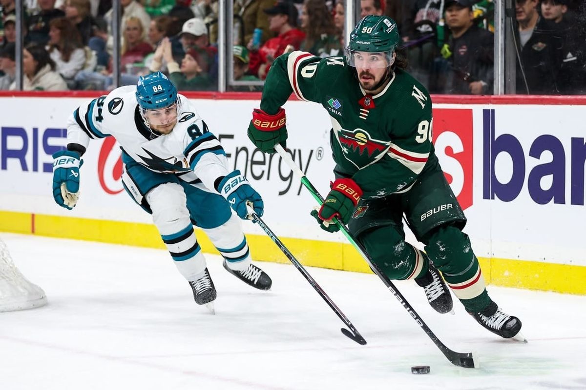 Mar 28, 2024; Saint Paul, Minnesota, USA; Minnesota Wild center Marcus Johansson (90) skates with the puck as San Jose Sharks defenseman Jan Rutta (84) defends during the second period at Xcel Energy Center.