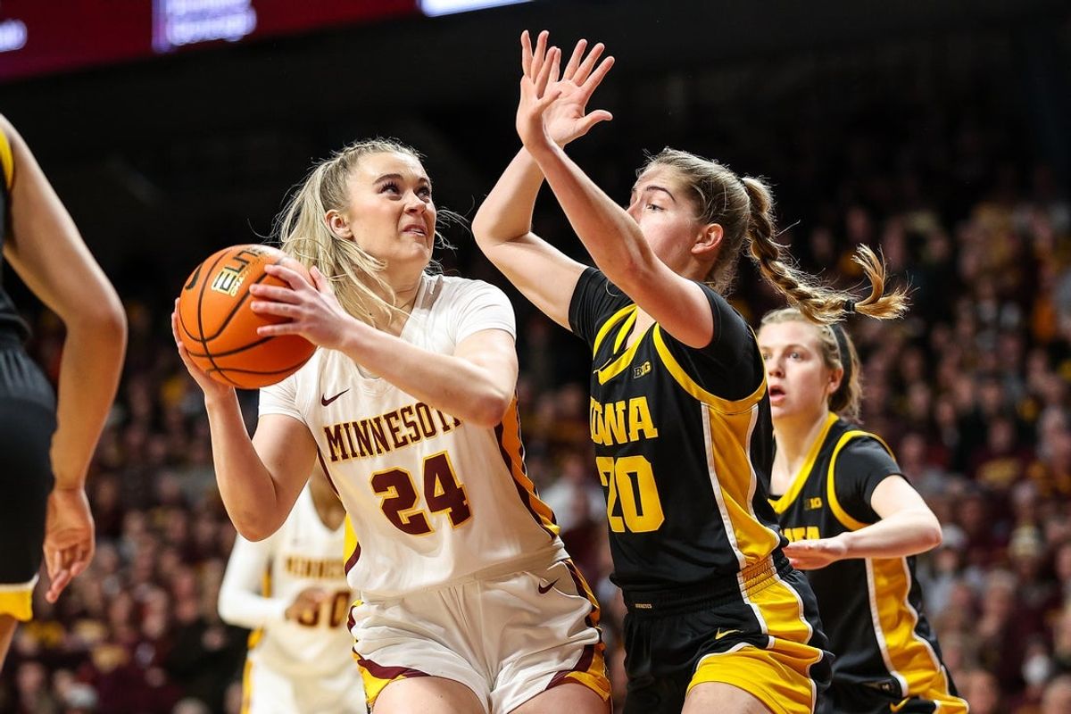 Feb 28, 2024; Minneapolis, Minnesota, USA; Minnesota Golden Gophers forward Mallory Heyer (24) shoots as Iowa Hawkeyes guard Kate Martin (20) defends during the first half at Williams Arena. Mandatory Credit: Matt Krohn-Imagn Images