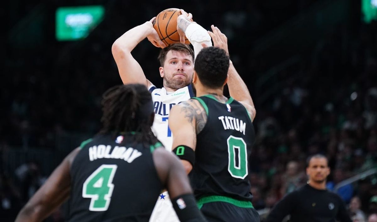 Mar 1, 2024; Boston, Massachusetts, USA; Dallas Mavericks guard Luka Doncic (77) looks to pass the ball against Boston Celtics forward Jayson Tatum (0) in the second quarter at TD Garden. Mandatory Credit: David Butler II-USA TODAY Sports