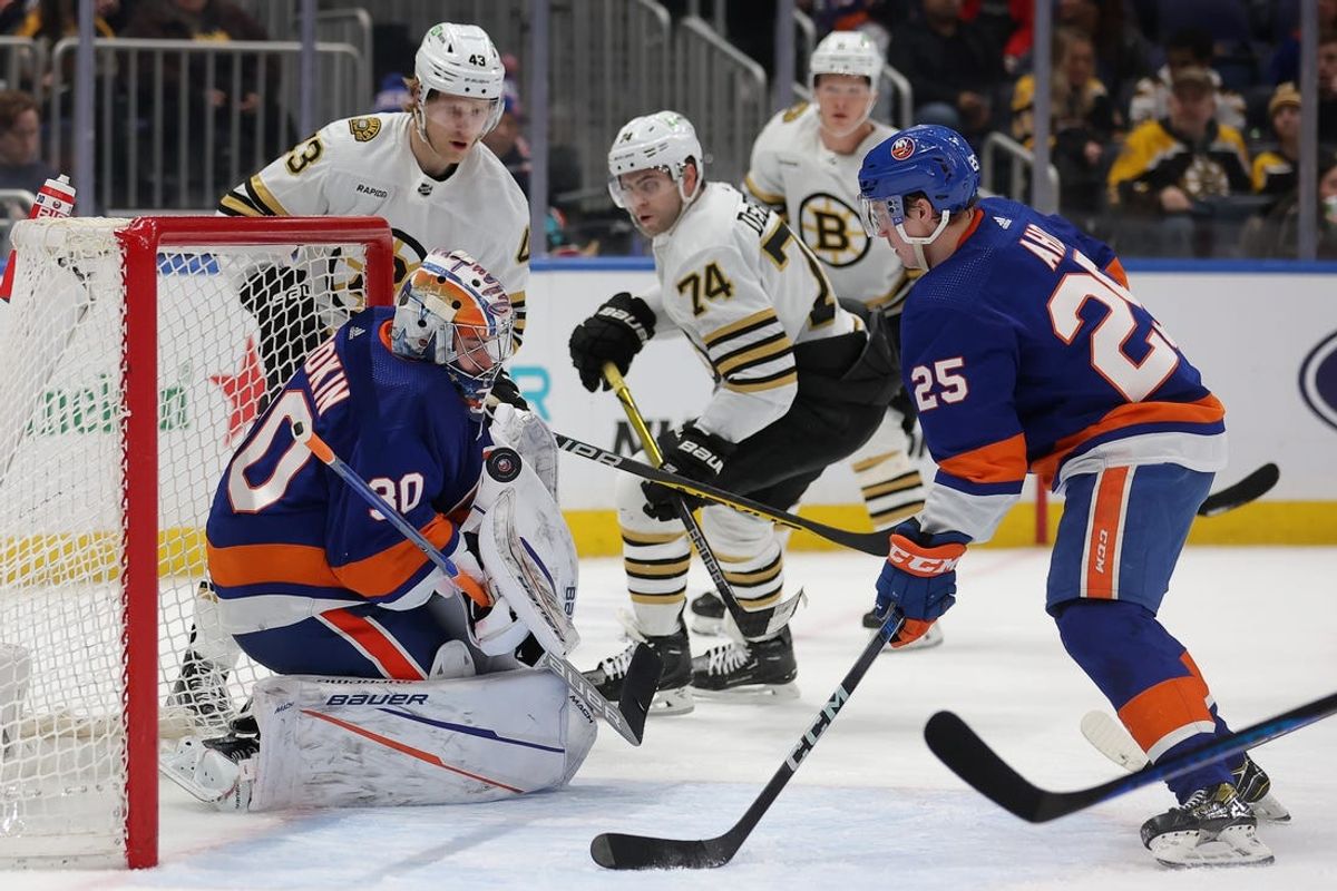 New York Islanders goaltender Ilya Sorokin (30) makes a save in front of Boston Bruins left wing Danton Heinen (43) and left wing Jake DeBrusk (74) and center Trent Frederic (11) and Islanders defenseman Sebastian Aho (25) during the third period at UBS Arena. Mandatory Credit: Brad Penner-USA TODAY Sports