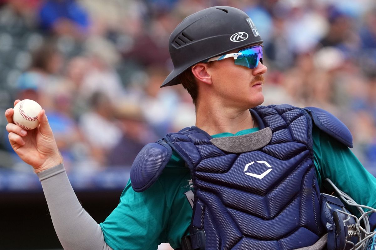 Mar 6, 2024; Surprise, Arizona, USA; Seattle Mariners catcher Blake Hunt (77) throws to the pitcher  during the second inning of the game against the Kansas City Royals at Surprise Stadium. Mandatory Credit: Joe Camporeale-Imagn Images
