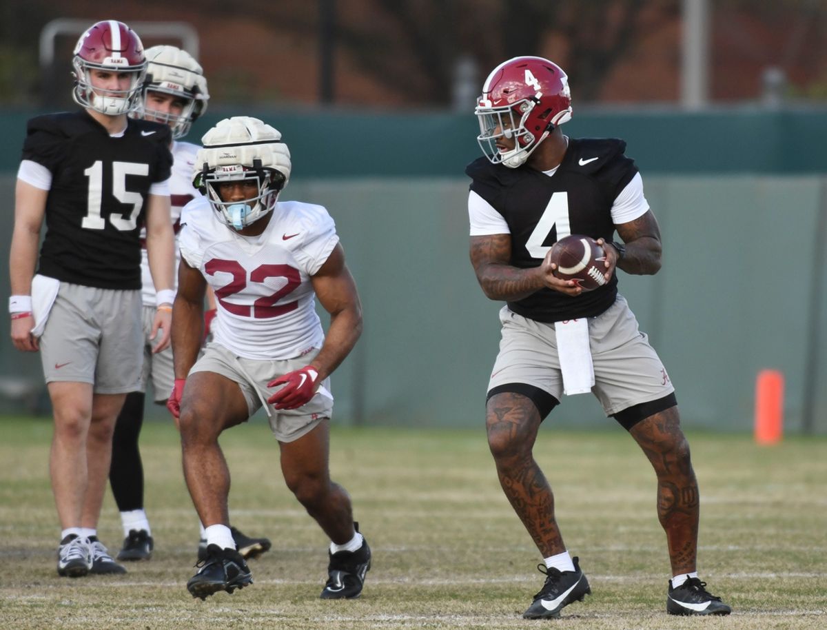 Mar 6, 2024; Tuscaloosa, Alabama, USA; Jalen Milroe turns to hand the ball off to Justice Haynes during practice for the Alabama Crimson Tide football team Wednesday.