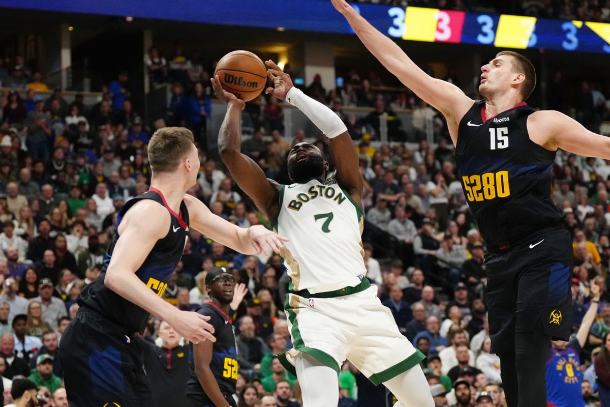 Mar 7, 2024; Denver, Colorado, USA; Boston Celtics guard Jaylen Brown (7) shoots between Denver Nuggets guard Christian Braun (0) and center Nikola Jokic (15) in the fourth quarter at Ball Arena. Mandatory Credit: Ron Chenoy-Imagn Images