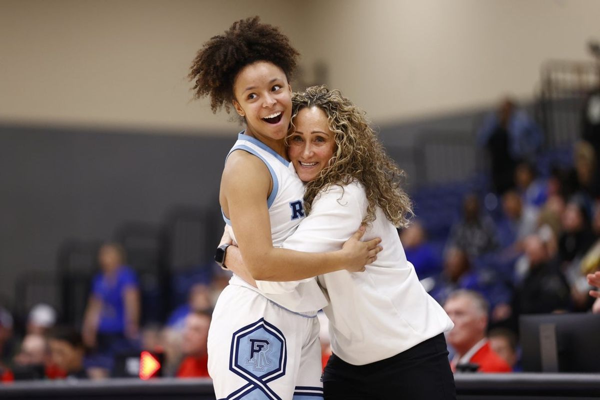 Mar 9, 2024; Henrico, VA, USA; Rhode Island Rams head coach Tammi Reiss (right) celebrate with Rams guard Ines Debroise (30) in the final seconds of the game after defeating the Saint Louis Billikens at Henrico Sports & Events Center. Mandatory Credit: Amber Searls-Imagn Images